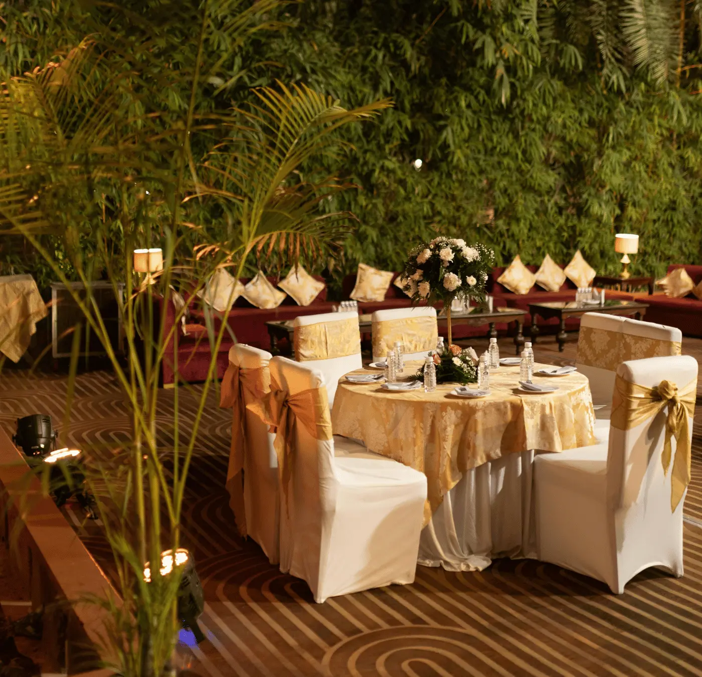 Elegant outdoor dinner table setup with floral centrepiece
